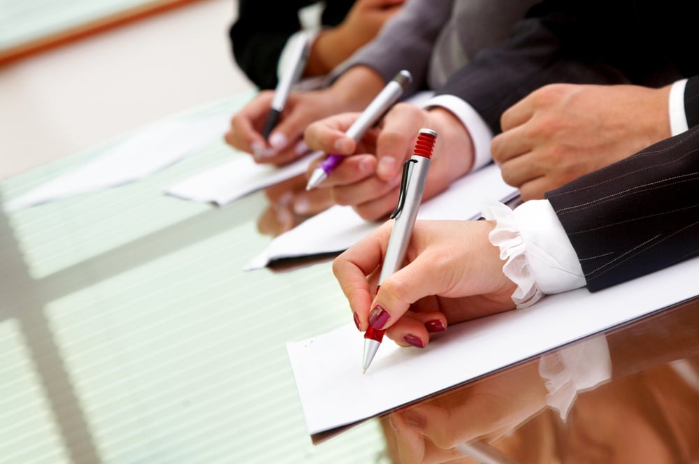 business people making notes during an office meeting